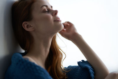 Close-up portrait of a young woman with eyes closed