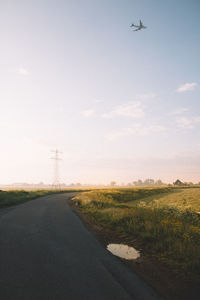 Road by landscape against sky