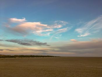 Scenic view of field against sky during sunset