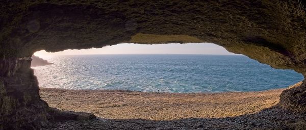 Scenic view of sea seen through cave