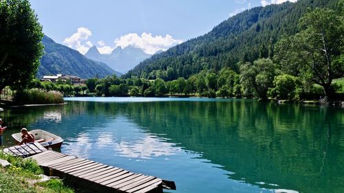 Scenic view of lake and mountains against sky