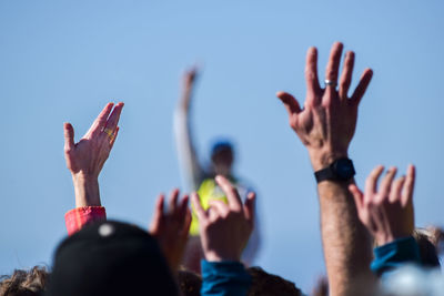 Protestors with hands raised at a protest music festival