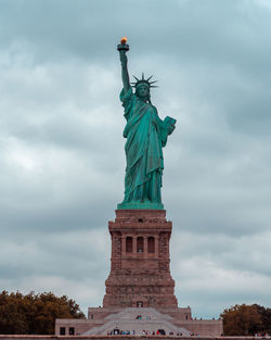 Low angle view of statue against cloudy sky