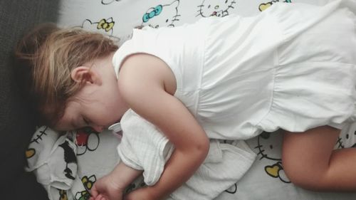 Cute girl sleeping on bed at home