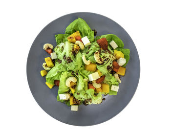 High angle view of chopped vegetables in bowl against white background