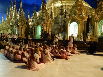 Group of people in temple outside building