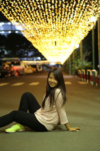 Portrait of a smiling young woman sitting outdoors