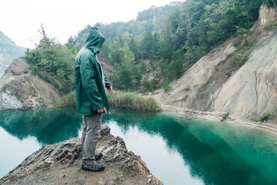 Rear view of man standing on rock