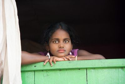 Portrait of girl leaning against wall