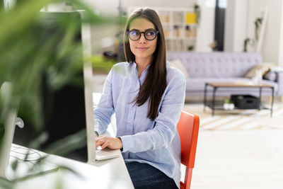 Portrait of young woman sitting outdoors