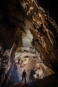 Low angle view of man standing in cave