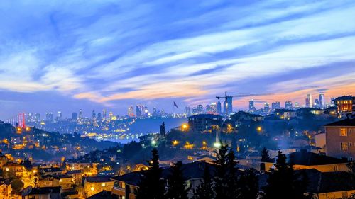 High angle view of illuminated buildings against sky at sunset