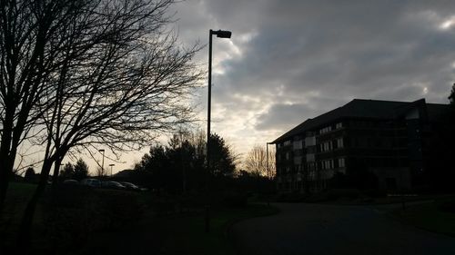 Empty road with buildings in background