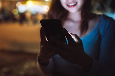 Midsection of man using mobile phone