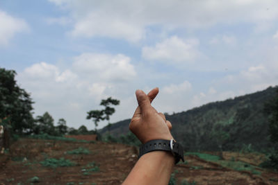 Korean direction love shaped hand pointing to the sky with beautiful countryside view