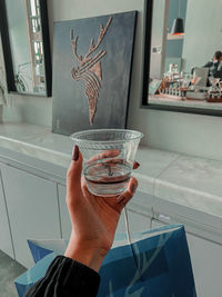 Close-up of hand holding glass window