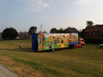 Graffiti on field against sky