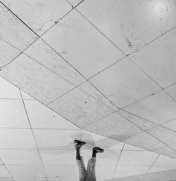 Low section of woman standing on tiled floor