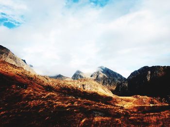 View of mountain range against cloudy sky