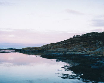 Scenic view of sea and rocks against sky