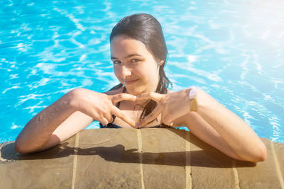 Portrait of woman swimming in pool