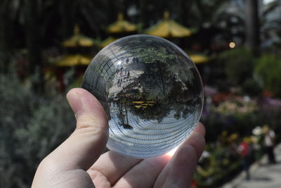 Close-up of hand holding crystal ball