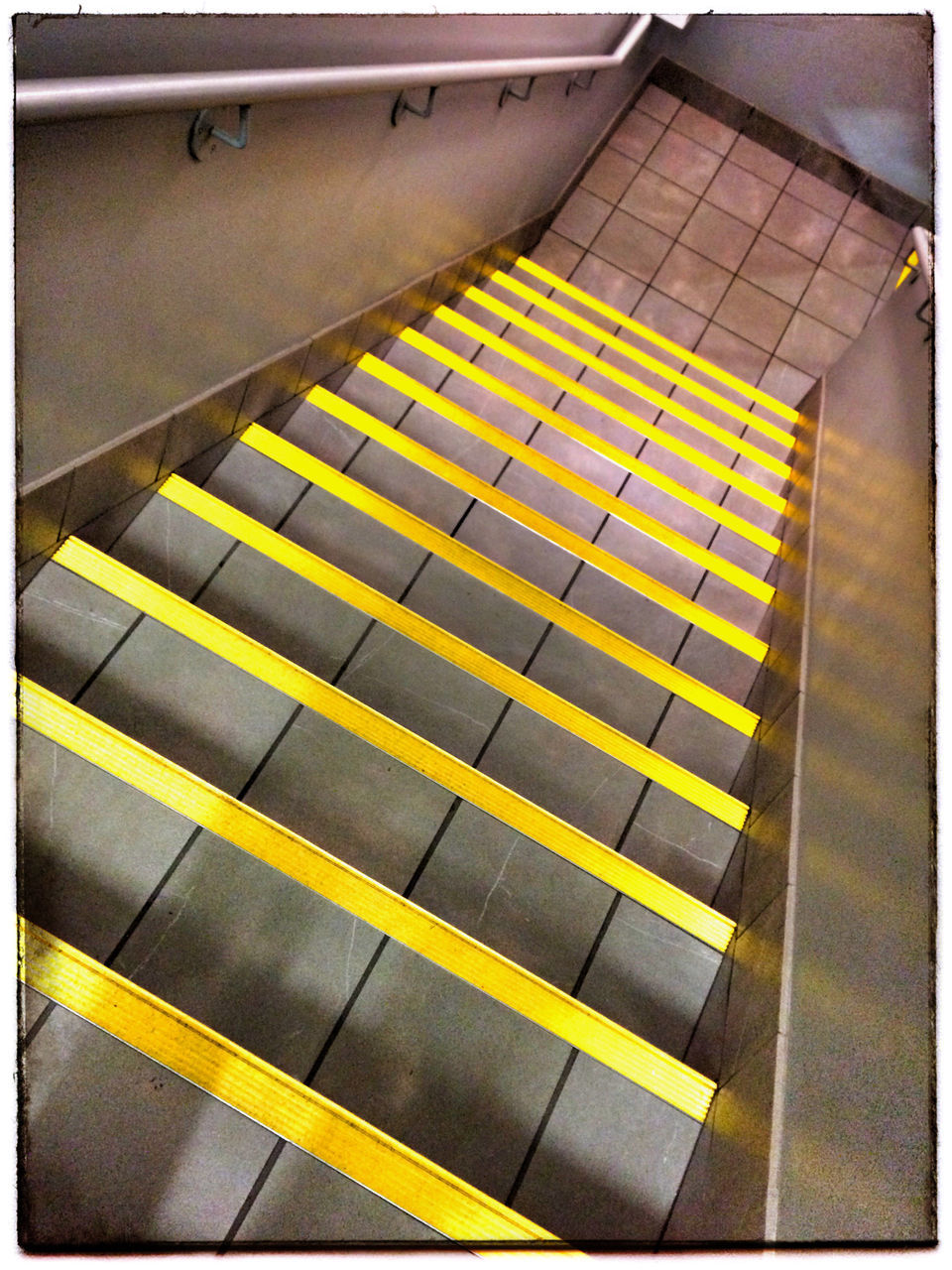 transfer print, indoors, yellow, auto post production filter, pattern, high angle view, illuminated, steps, tile, built structure, tiled floor, architecture, steps and staircases, multi colored, in a row, wall - building feature, ceiling, no people, staircase, flooring