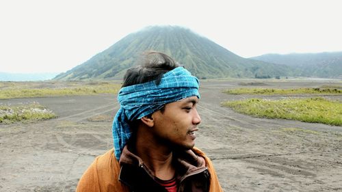 Portrait of senior man on land against clear sky