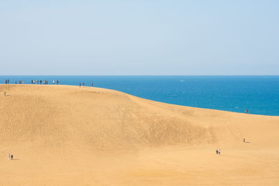 Scenic view of beach against blue sky