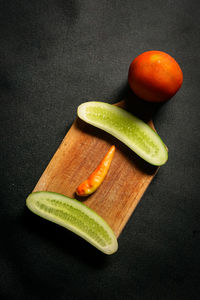 High angle view of orange fruit against black background