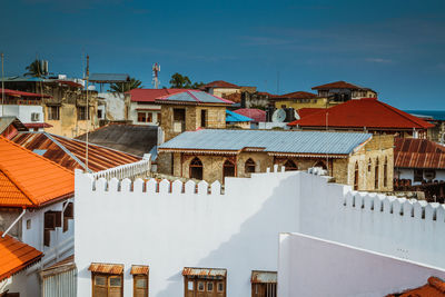 Exterior of houses in town against clear blue sky