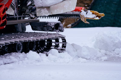 Close-up of snow cat preparing ski slope 