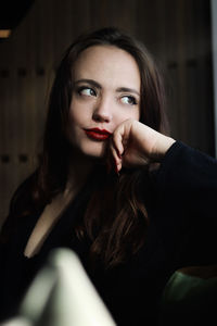 Portrait of young woman sitting at home