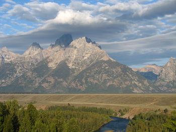 Scenic view of mountains against cloudy sky