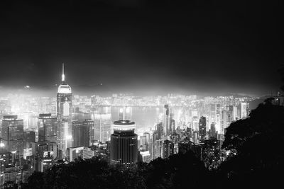 Illuminated cityscape against sky at night