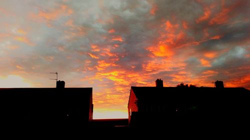 Low angle view of silhouette buildings against sky during sunset