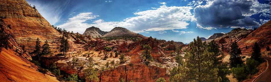 Panoramic view of mountains against cloudy sky