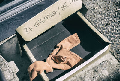 High angle view of clothing in donation box at street