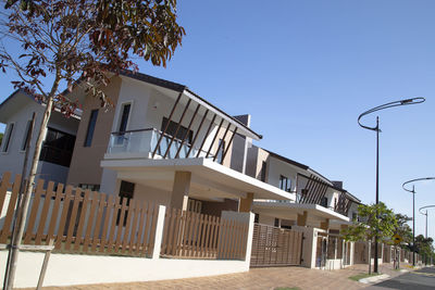 Residential buildings against clear blue sky