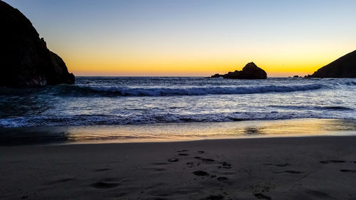 Scenic view of sea against clear sky during sunset