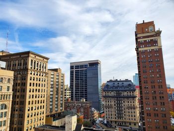 Low angle view of buildings in city against sky