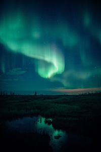 Scenic view of lake against sky at night