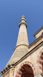 Low angle view of clock tower against blue sky