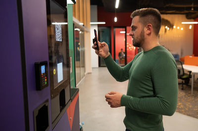 Young man using mobile phone at home