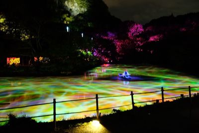 Illuminated light trails on street at night