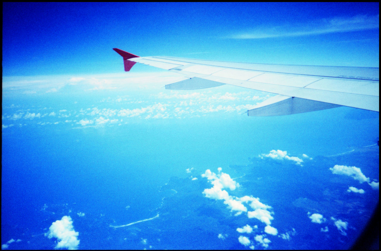 CLOSE-UP OF AIRPLANE WING AGAINST SKY