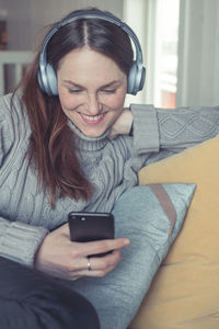 Young man using mobile phone while sitting on table