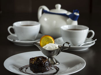 Close-up of cake with tea on table