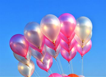 Low angle view of balloons against sky