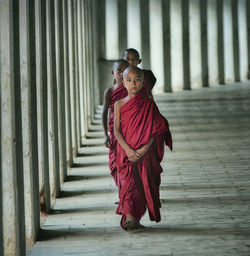 Full length of woman standing against wall